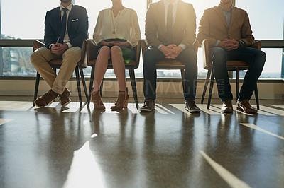 Buy stock photo Cropped shot of a group of unrecognizable businesspeople sitting in line while waiting to be interviewed