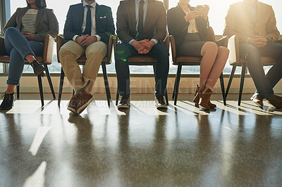 Buy stock photo Cropped shot of a group of unrecognizable businesspeople sitting in line while waiting to be interviewed