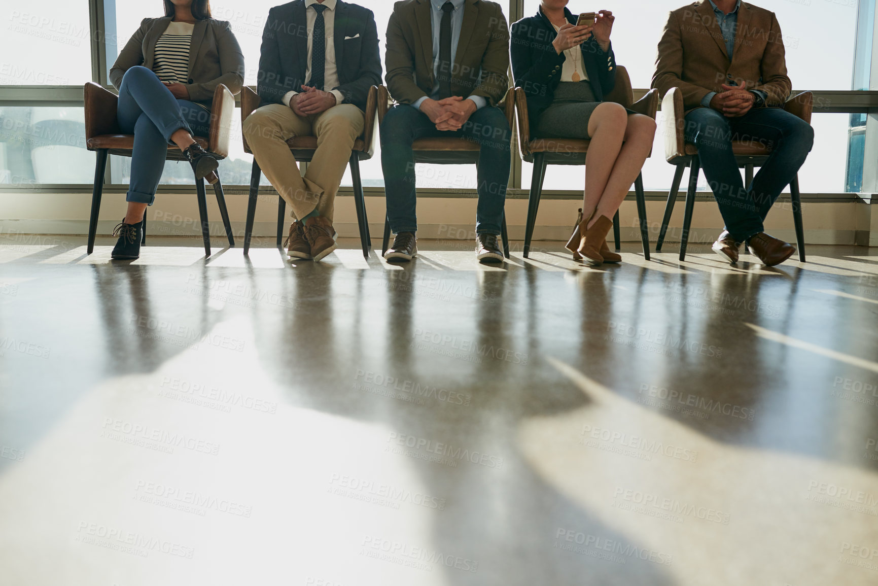 Buy stock photo Waiting, onboarding and legs of business people in office for performance review meeting with hr. Recruitment process, row and professional hiring candidates in line for interview in workplace lobby.