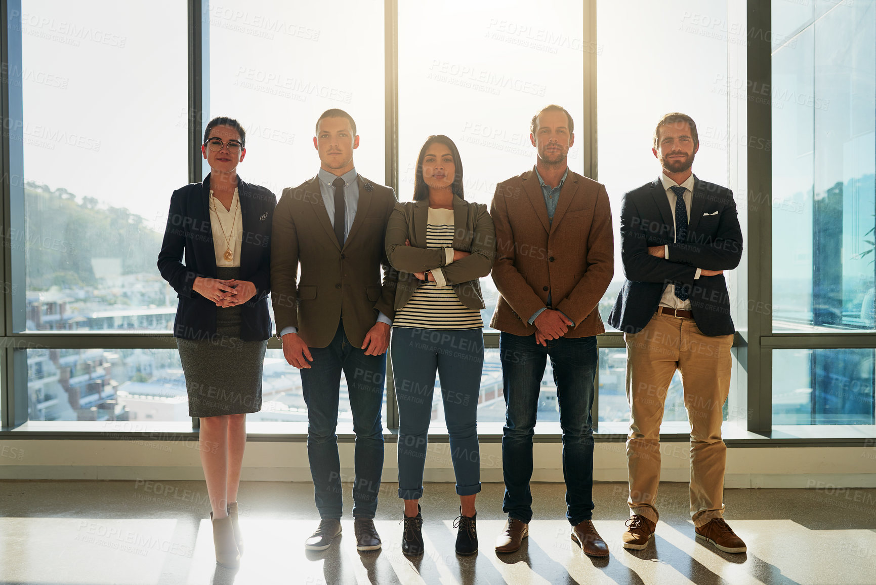 Buy stock photo Full length portrait of a group of businesspeople standing in their office