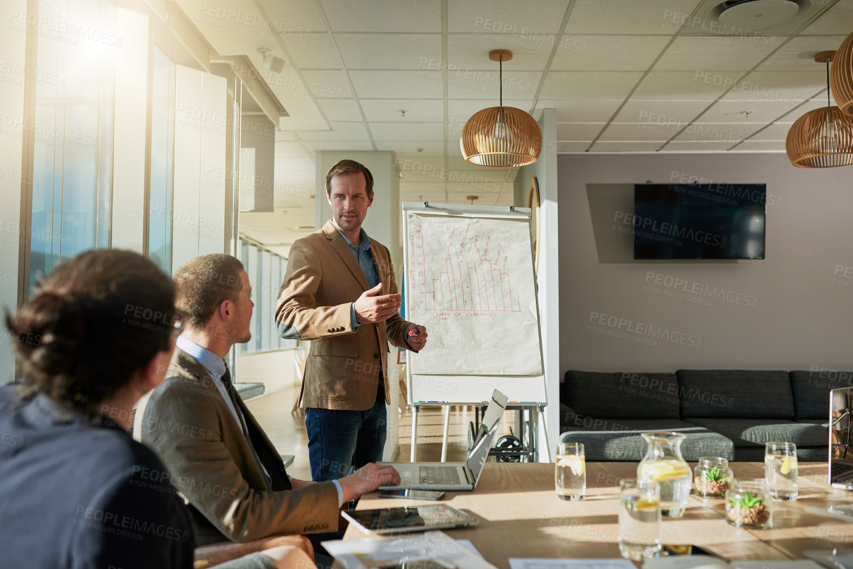 Buy stock photo Cropped shot of a businessman giving a presentation during a meeting in the boardroom