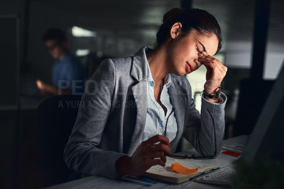Buy stock photo Shot of a young attractive  businesswoman working late at night in a modern office