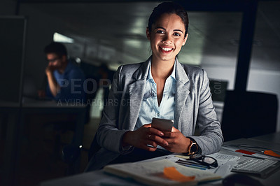 Buy stock photo Shot of a young attractive businesswoman working late at night in a modern office
