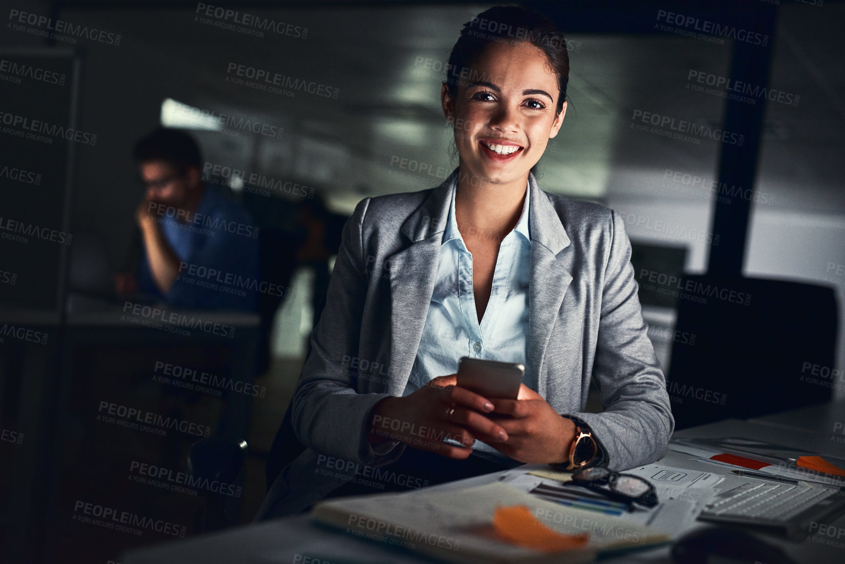 Buy stock photo Shot of a young attractive businesswoman working late at night in a modern office