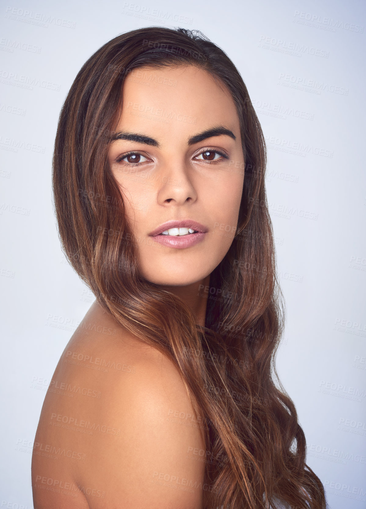 Buy stock photo Studio shot of a beautiful young woman posing against a purple background