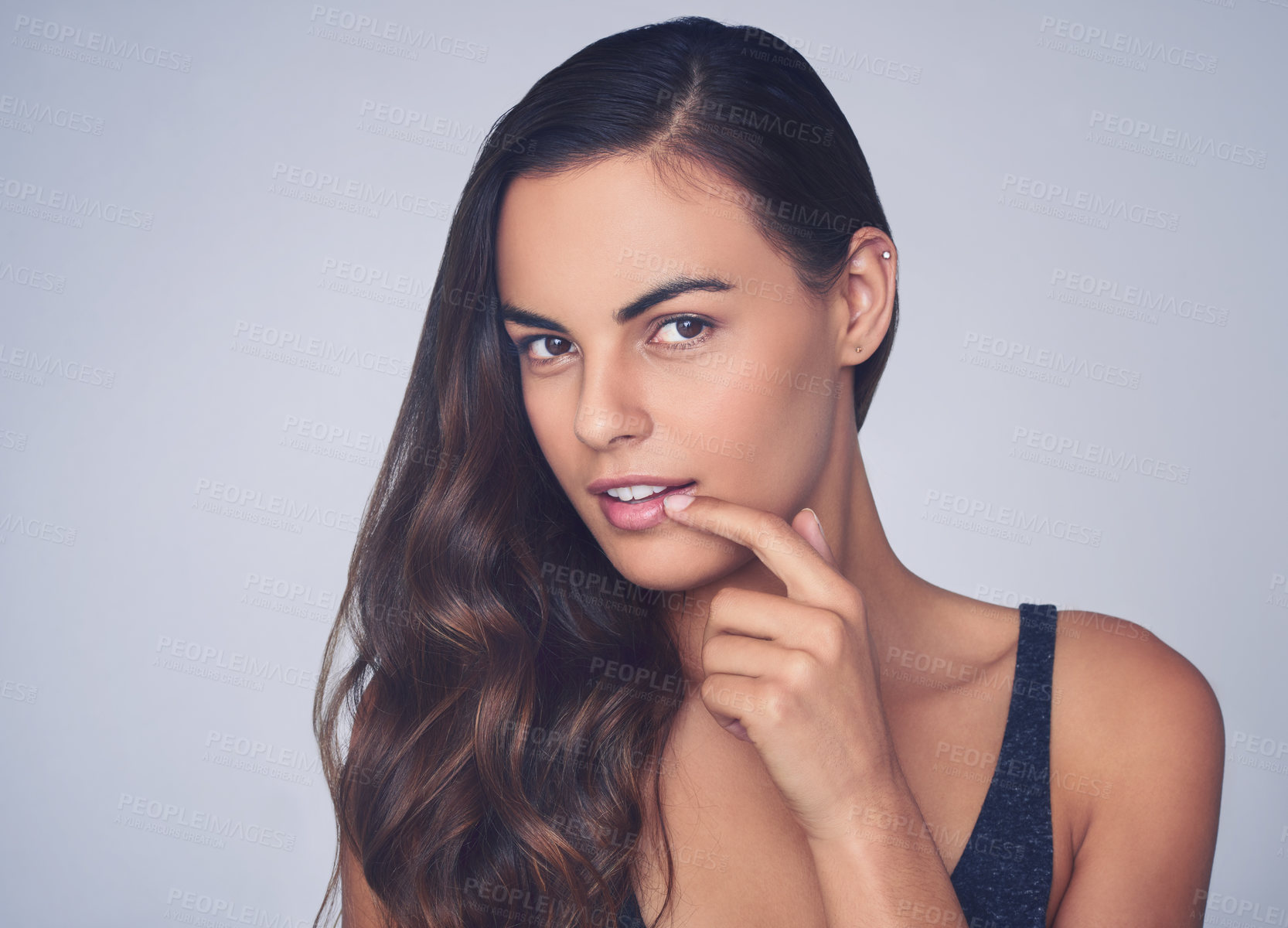 Buy stock photo Studio shot of a beautiful young woman posing against a purple background