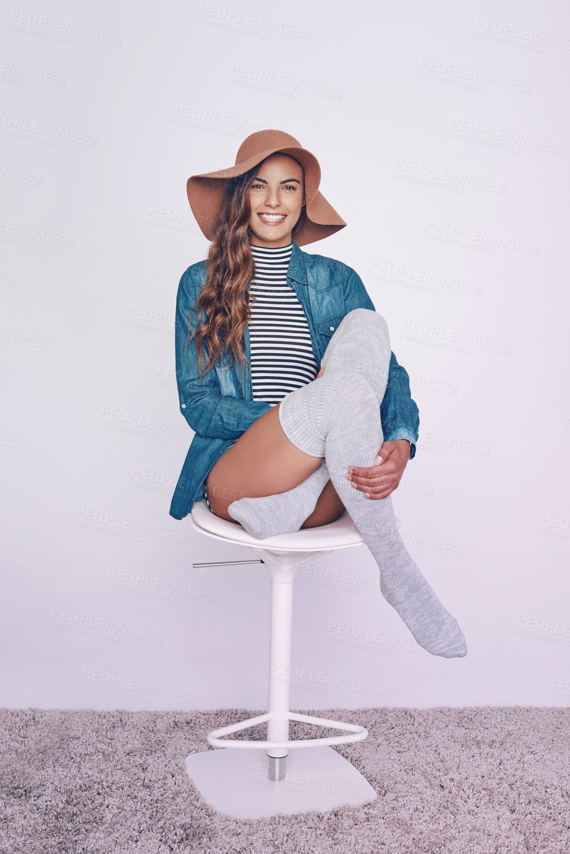 Buy stock photo Fashion, happy and portrait of woman on stool in studio with stylish, trendy and casual outfit for confidence. Smile, chair and female person from Canada with hat and chic clothes by white background