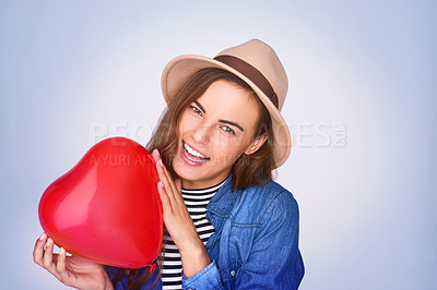 Buy stock photo Woman, portrait and heart balloon with smile in studio for gratitude, romance or symbol of love. Happy, care and female person with inflatable shape by white background for kindness, emoji or support