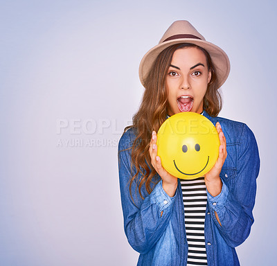 Buy stock photo Happy woman, portrait or emoji with balloon or surprise reaction for review in studio on a purple background. Young, female person or model with smile or expression for sign, feedback or mockup space