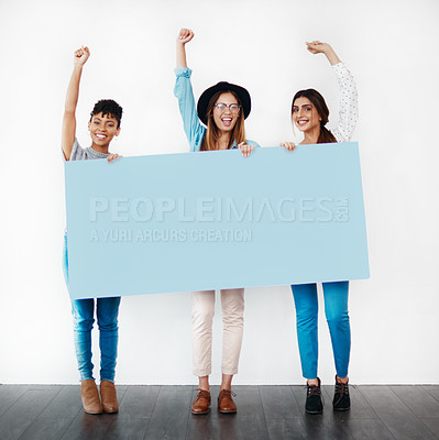 Buy stock photo Studio shot of a group of young women holding a blank placard and cheering against a white background