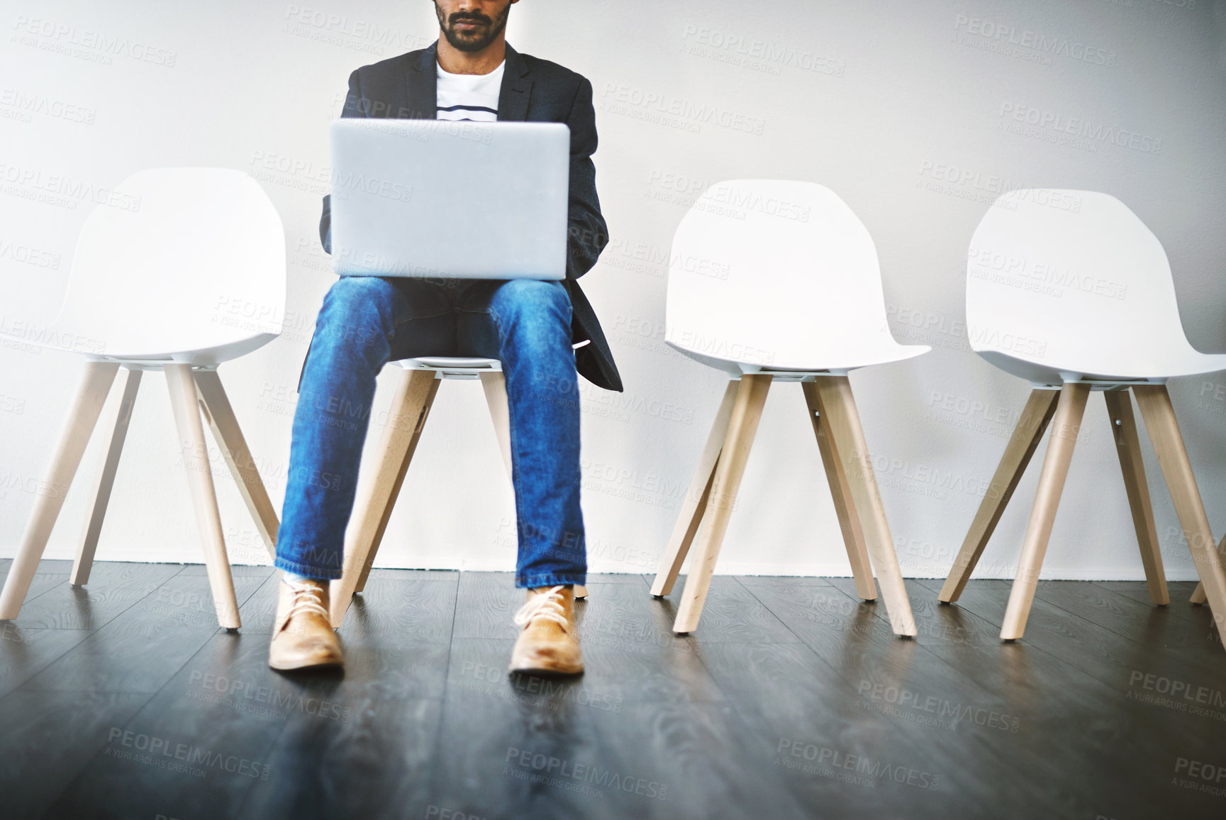 Buy stock photo Waiting room, businessman and laptop for recruitment, research and planning questions for hr interview. Wall background, male candidate and digital for information, opportunity and reading portfolio