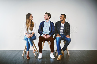 Buy stock photo Shot of a group of young businesspeople waiting in line for a job interview