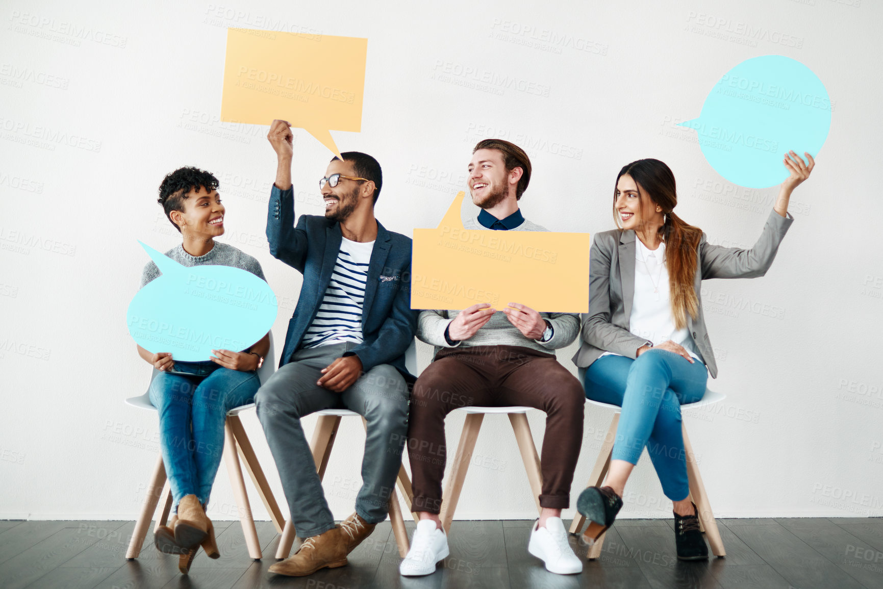 Buy stock photo Shot of a diverse group of creative employees holding up speech bubbles inside