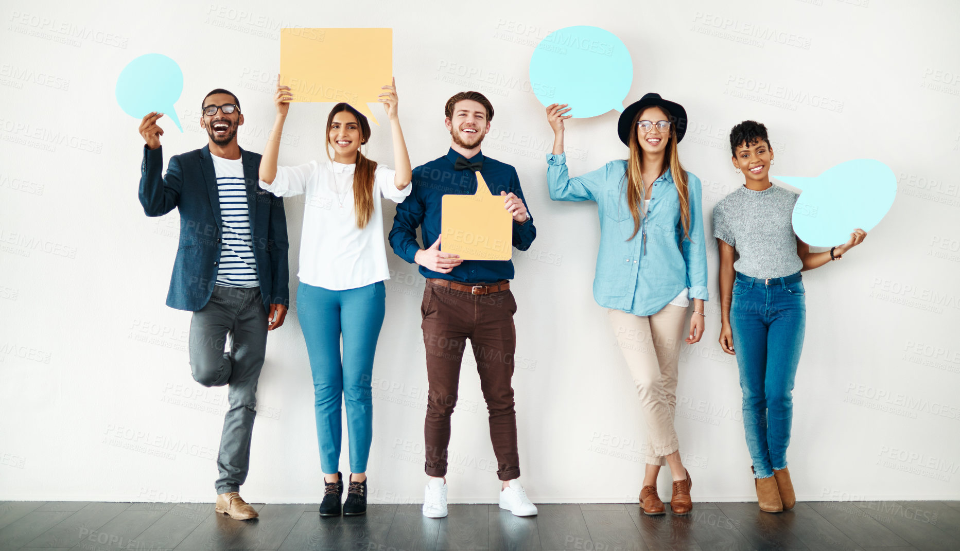 Buy stock photo Happy, portrait and business people with speech bubble on wall for social media or review on a white background. Young, group or employees with smile, sign or shape for comment, feedback or mockup