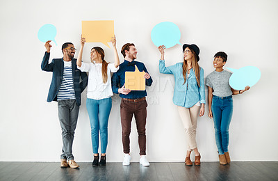 Buy stock photo Shot of a diverse group of creative employees holding up speech bubbles inside