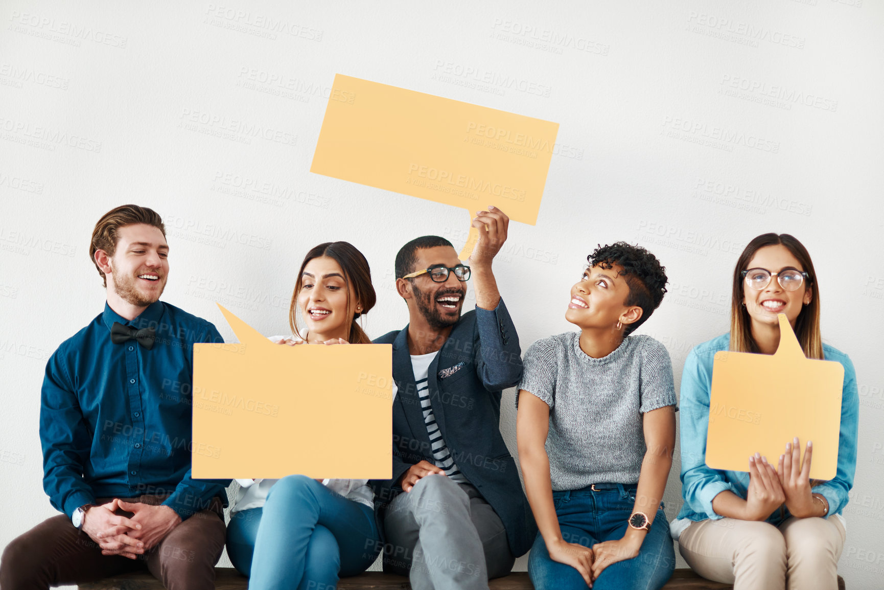 Buy stock photo Happy people, wall and waiting room with speech bubble for social media or review on a white studio background. Young, group or employees with smile, sign or shape for comment, feedback or mockup