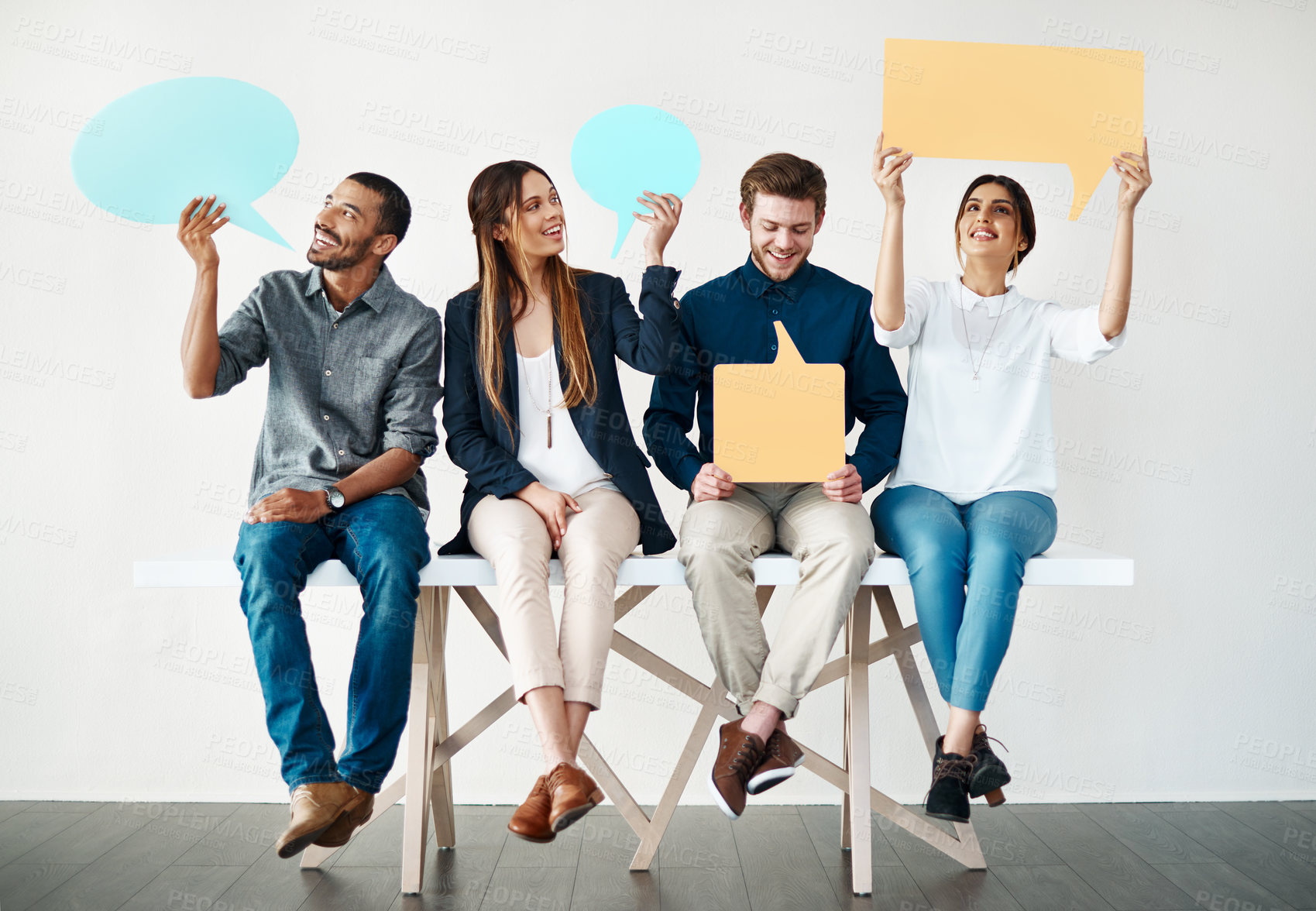 Buy stock photo Happy, business people or waiting room with speech bubble on bench for social media or review on a white studio background. Young, group or employees with smile, sign or shape for comment or feedback