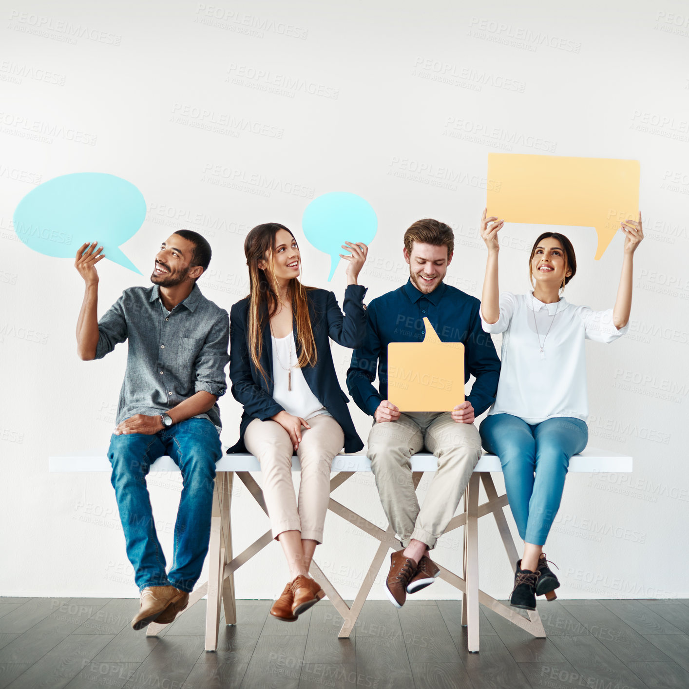 Buy stock photo Happy, creative people or waiting room with speech bubble on bench for social media or review on a white studio background. Young, group or employees with smile, sign or shape for comment or feedback