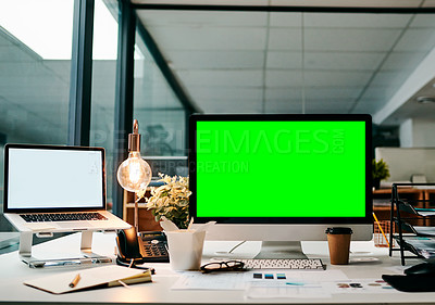 Buy stock photo Shot of a desktop computer with a green screen on a table inside of a office during the day