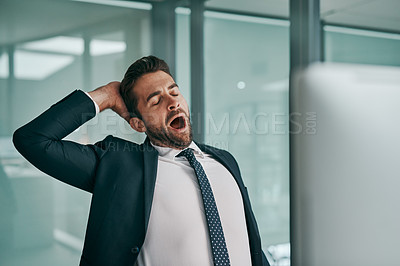 Buy stock photo Shot of a tired young businessman stretching while  yawning with his eyes closed inside of the office