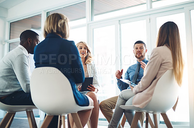 Buy stock photo Cropped shot of a group of corporate colleagues meeting in their office