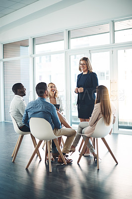 Buy stock photo Full length shot of a young businesswoman addressing her colleagues during a meeting in the office