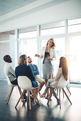 Buy stock photo Full length shot of a young businesswoman addressing her colleagues during a meeting in the office