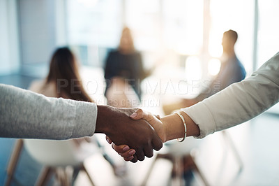 Buy stock photo Cropped shot of two unrecognizable colleagues shaking hands during a meeting in the office