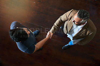 Buy stock photo Startup, top view or business people shaking hands in office for b2b negotiation, project and meeting. Men, collaboration or above of handshake to welcome an employee speaking of partnership deal