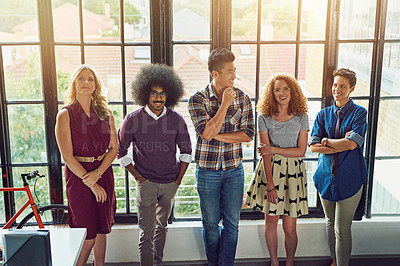 Buy stock photo Shot of a group of designers standing at a window in an office