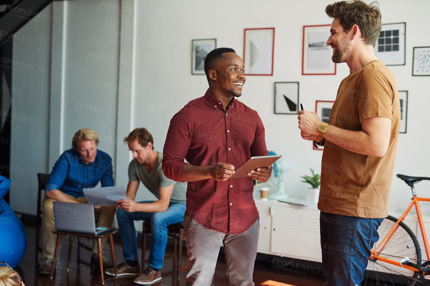 Buy stock photo Design, tablet and talking with business men in creative workplace together for meeting or planning. Collaboration, conversation or technology with colleague people in office for project discussion