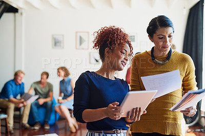 Buy stock photo Shot of two designers discussing something in an office