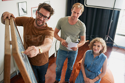 Buy stock photo Shot of a group of creative workers having a brainstorming session in an office