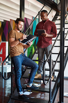 Buy stock photo Shot of two designers discussing something in an office