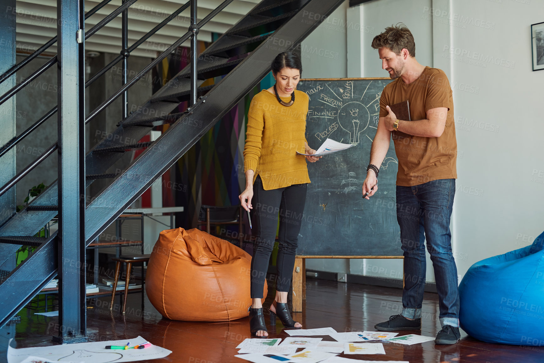 Buy stock photo Shot of two designers discussing something in an office
