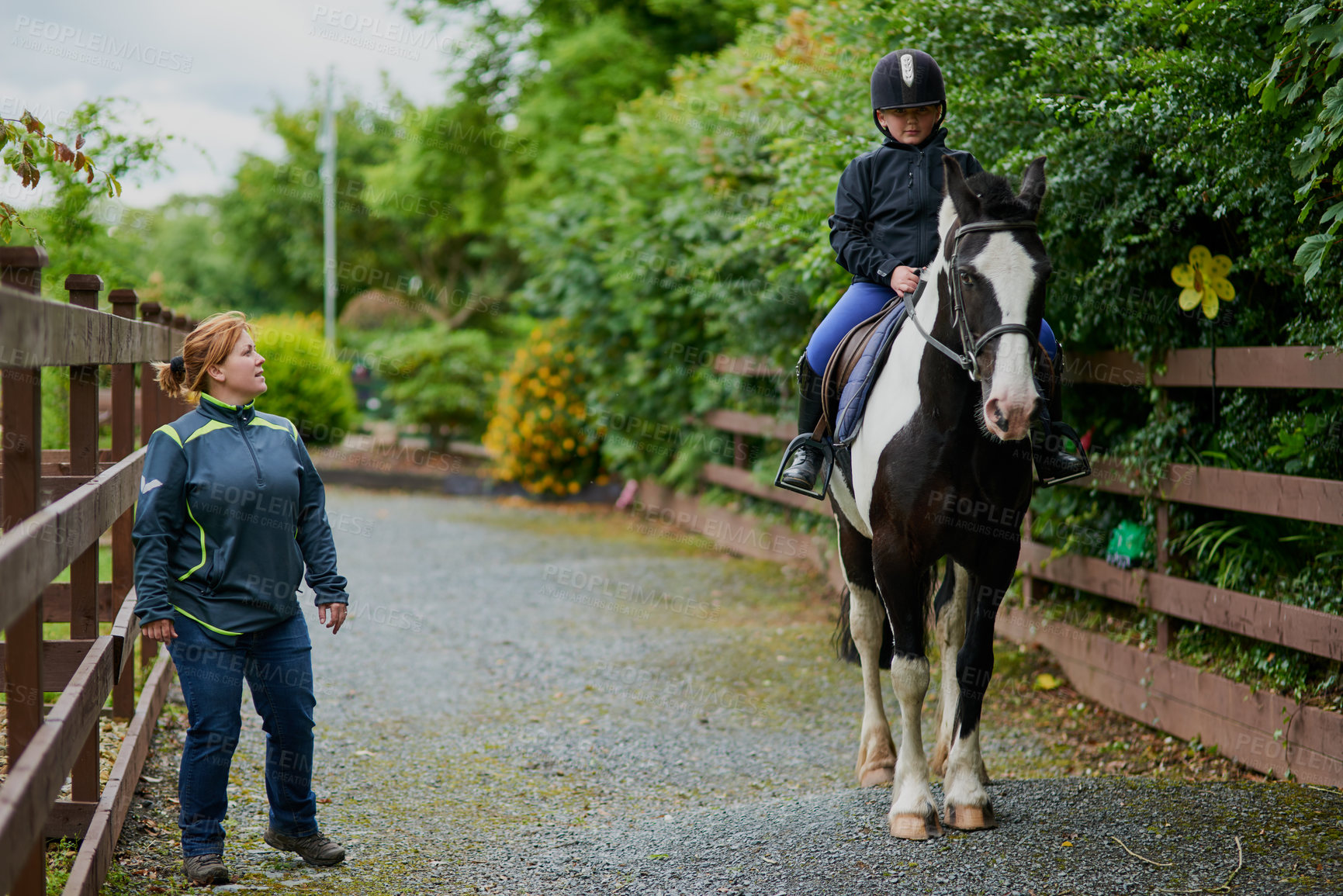 Buy stock photo Girl, horse and riding in countryside for equestrian, development and learning with instructor. Teenager, animal and pet on farm for workout, teaching and fitness with training, exercise and helmet
