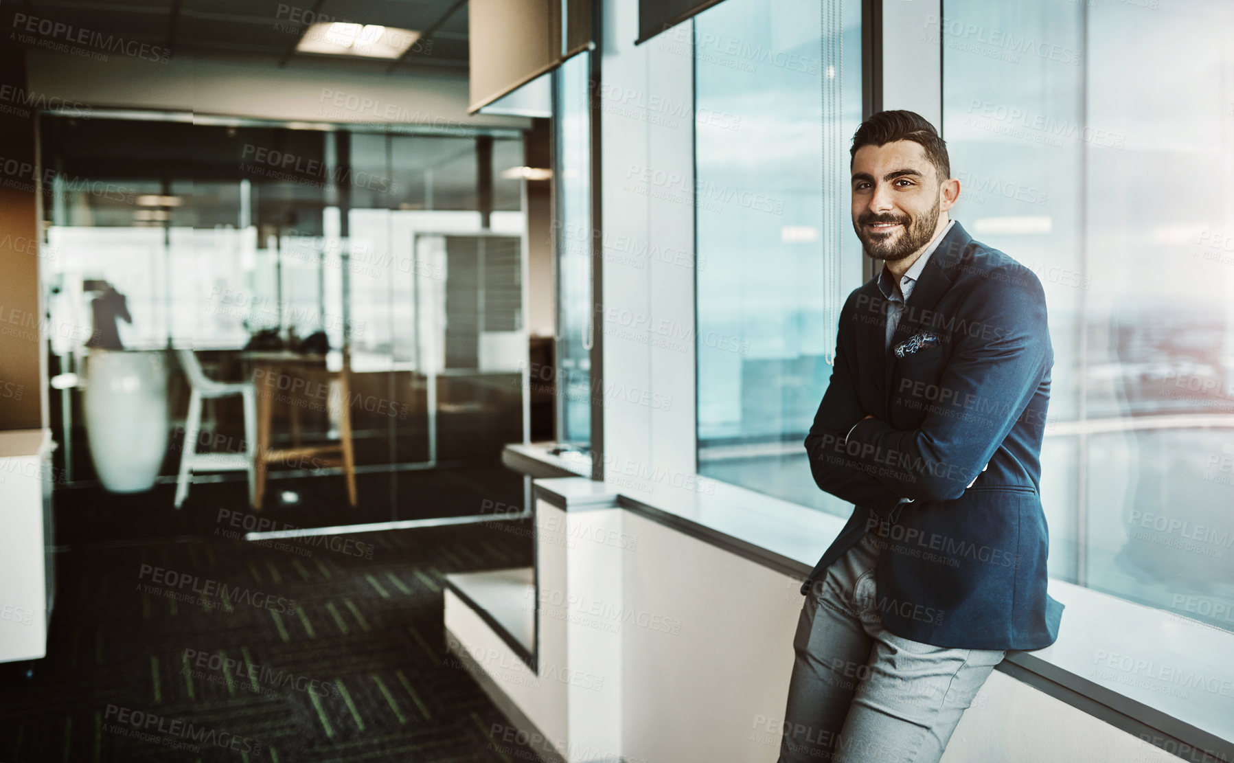 Buy stock photo Portrait of a confident young businessman working in a modern office