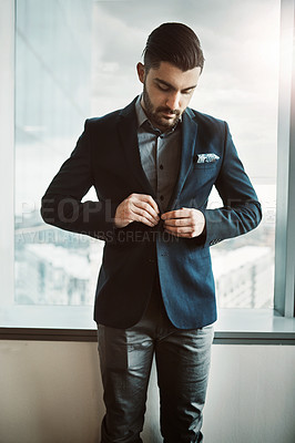 Buy stock photo Suit, fashion and businessman by window in office preparing for open house appointment with client. Style, professional and male realtor tying jacket button for getting ready at real estate agency.