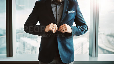 Buy stock photo Cropped shot of a stylish businessman button his jacket in a modern office