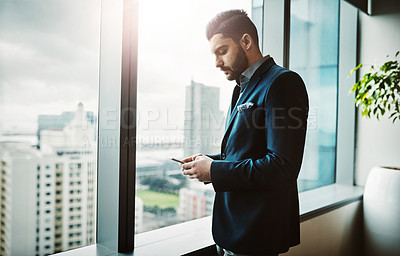 Buy stock photo Office, window and businessman with phone, search or reading social media, newsletter or client communication. Smartphone, research and male entrepreneur with app for email, chat or deal notification