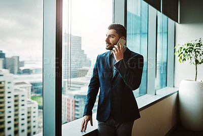 Buy stock photo Shot of a young businessman working in a modern office
