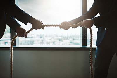 Buy stock photo Cropped shot of two businessmen pulling on a rope in a game of tug of war