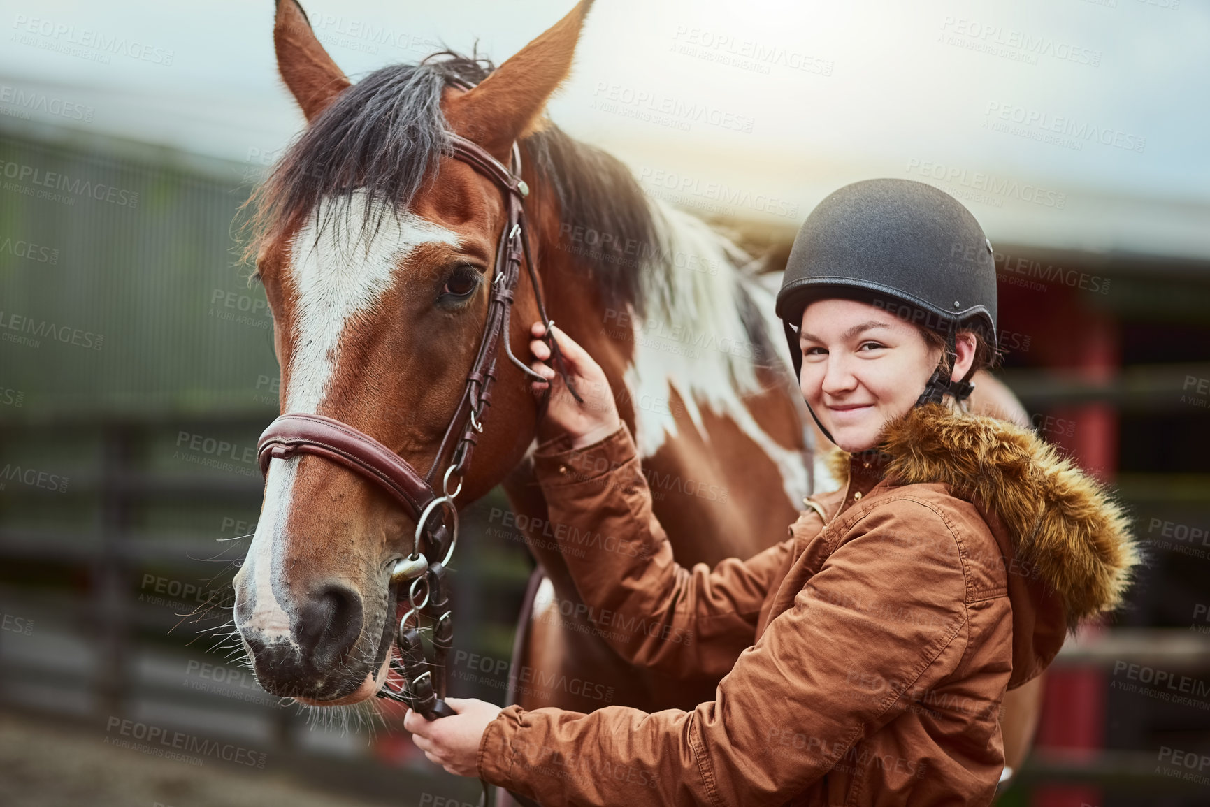 Buy stock photo Horse, portrait and girl prepare bridle at farm for race, sport and training at countryside ranch. Animal, equestrian and adjust reins for riding with pet for safety, care and happy teenager outdoor