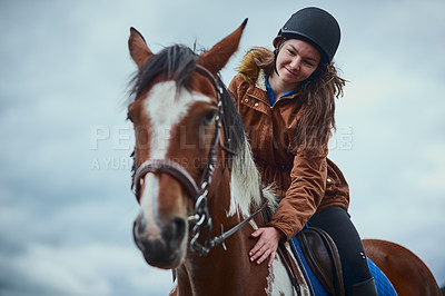 Buy stock photo Horse, smile and child riding on farm for sport, countryside training and equestrian development. Below, girl and stallion balance for exercise practise, wellness hobby or ranch cloudy sky of support