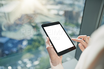 Buy stock photo Shot of a unrecognizable person browsing on a digital tablet with the city in the background