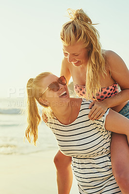 Buy stock photo Happy, lesbian and couple with piggyback at beach for summer vacation, bonding and travel together. Smile, lgbtq women and love for support, ocean sunshine and sunglasses of romance date in Miami