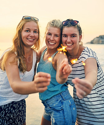 Buy stock photo Hands, sparklers and beach with friends portrait at sunset party for summer, vacation or holiday in nature together. New years, firework or celebration with people, bonding and drinking by Miami sea