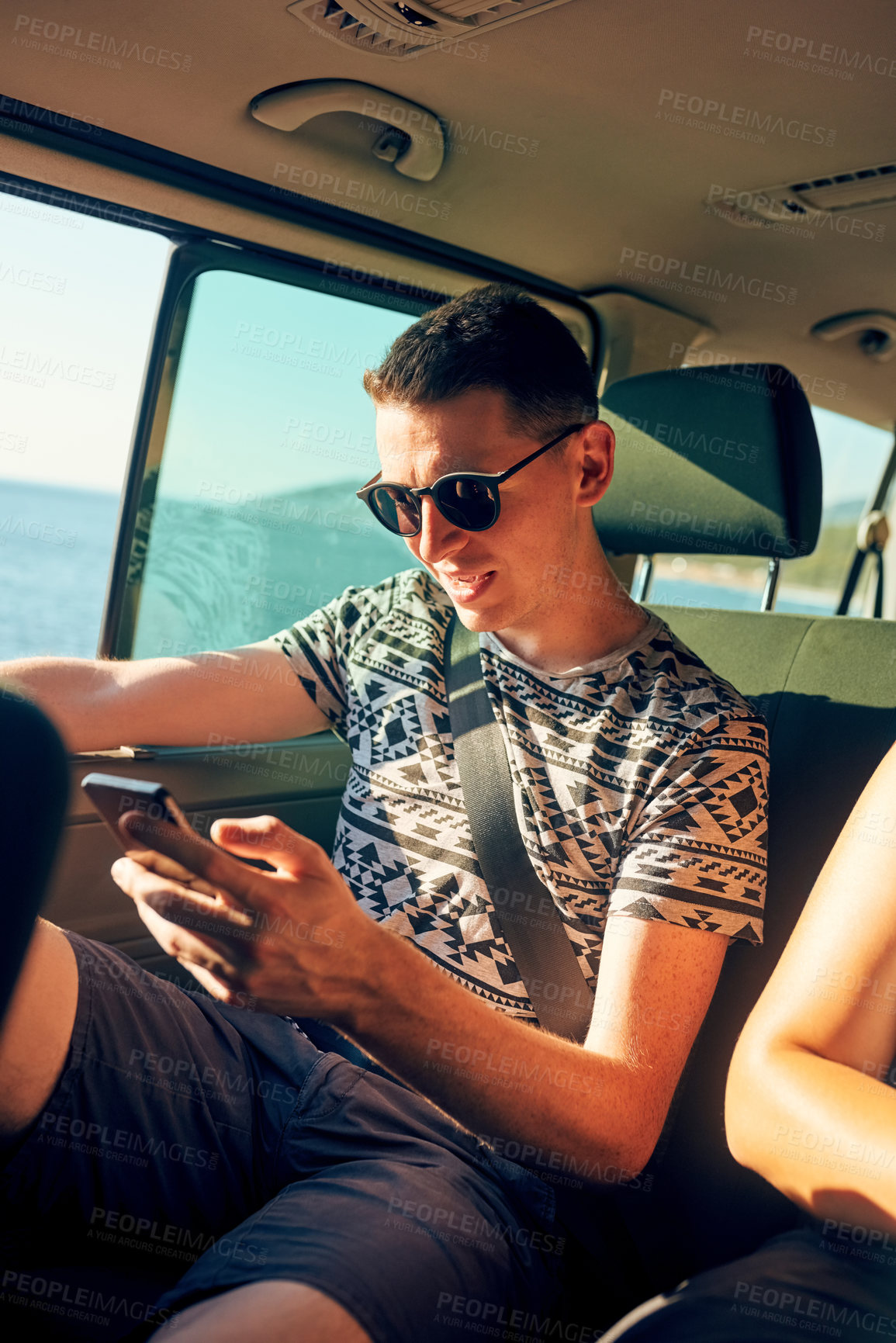 Buy stock photo Man, phone and sunglasses in car for road trip, social media and map app for navigation. Passenger, mobile and journey in vehicle for travel, changing music and communication on internet for holiday