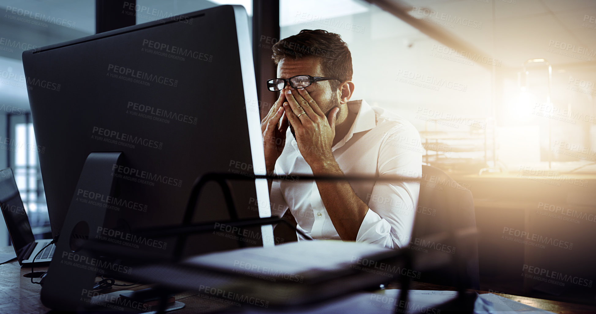 Buy stock photo Office, man and tired on computer with research for deadline and overtime as project manager. Male person, employee and exhausted or burnout with fatigue on internet for business and planning