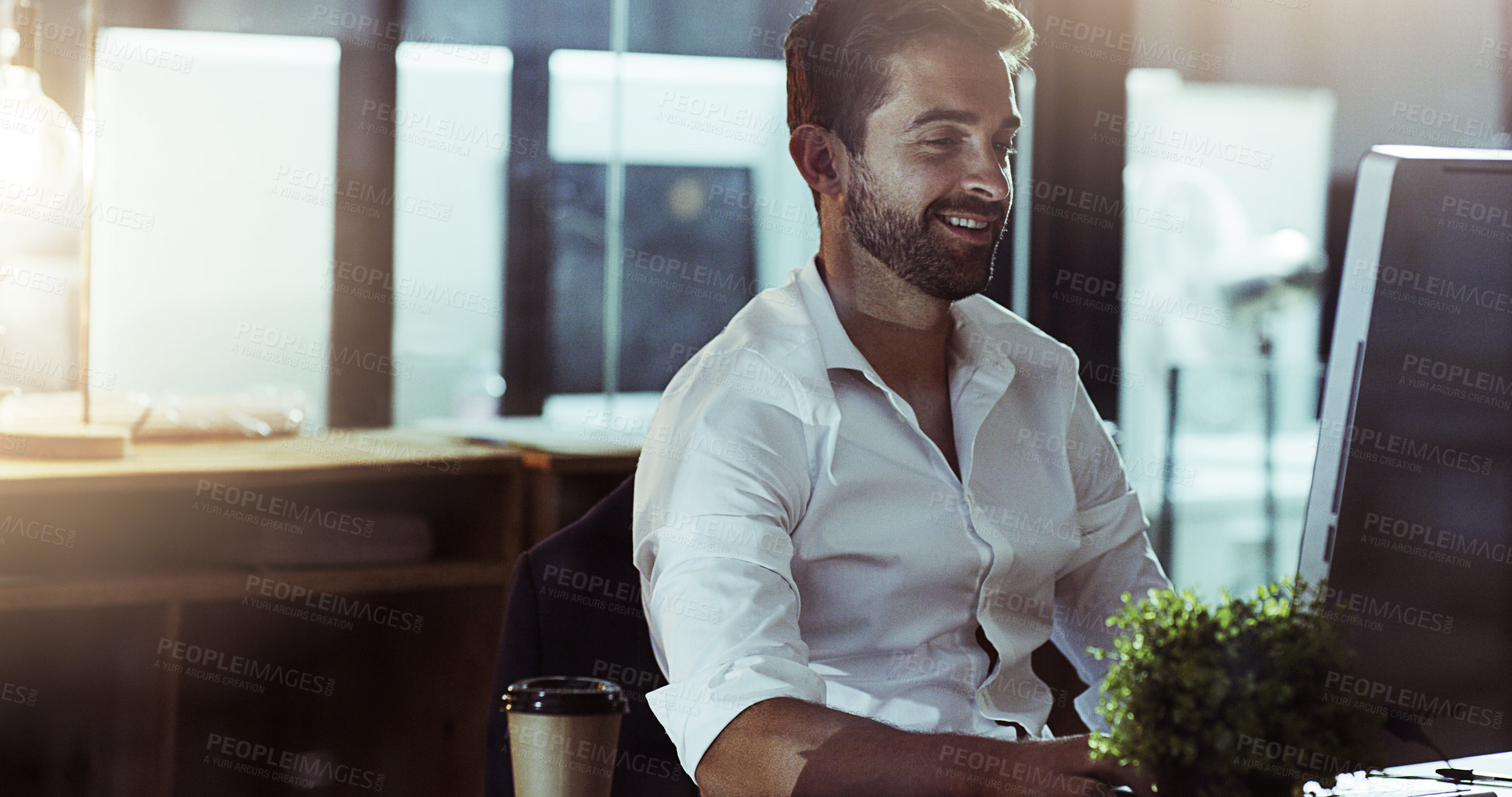 Buy stock photo Cropped shot of a handsome young businessman working late in the office